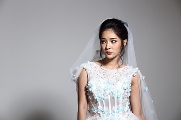 Fototapeta na wymiar Lovely Asian Beautiful Woman bride in white wedding gown dress with lace, black hair