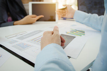 Investor executive discussing plan financial graph data on office table with laptop and tablet, finance, accounting, investment, meeting.