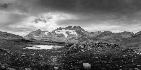 Cloudy mountains and small alpine lake (AA Edit)