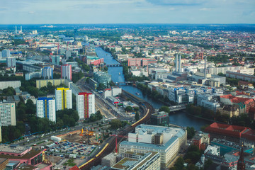 Fototapeta na wymiar Aerial view of Berlin with skyline and scenery beyond the city, Germany, seen from the observation deck of TV tower