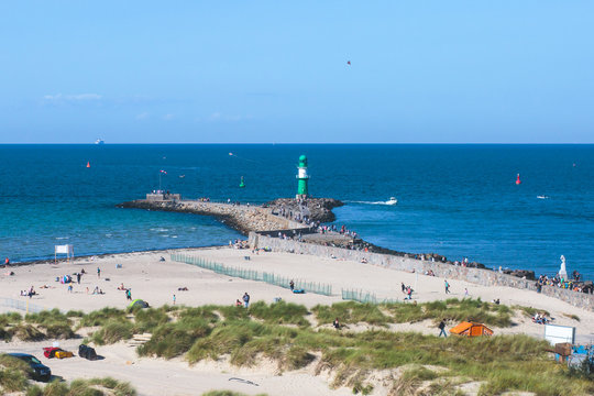 Beautiful summer vibrant view of Warnemunde, Rostock, Germany, popular german seaside resort, with beach, seashore and lighthouse