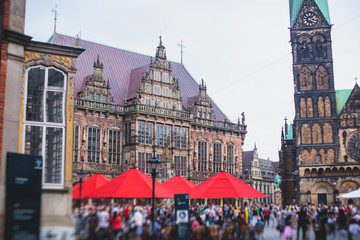 View of Bremen market square with Town Hall, Roland statue and crowd of people, historical center,...