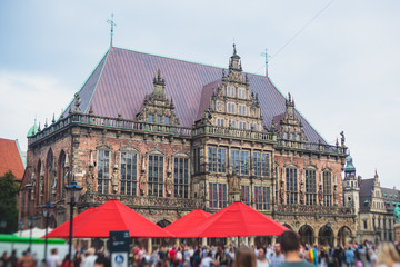 View of Bremen market square with Town Hall, Roland statue and crowd of people, historical center,...
