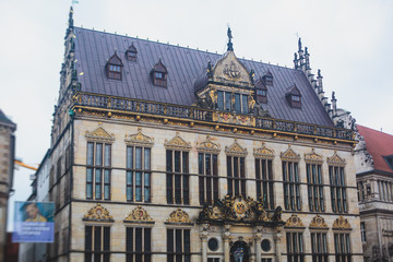 View of Bremen market square with Town Hall, Roland statue and crowd of people, historical center, Germany