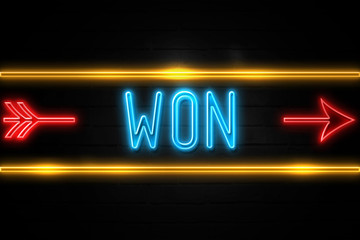 Obraz premium Won - fluorescent Neon Sign on brickwall Front view