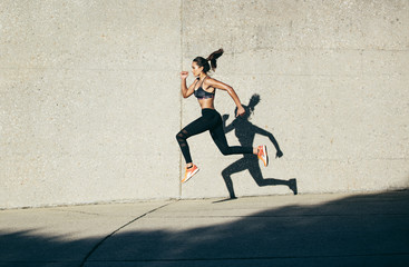 Sportswoman running and exercising outdoors