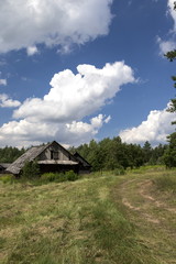 Old wooden houses on a rural landscape background