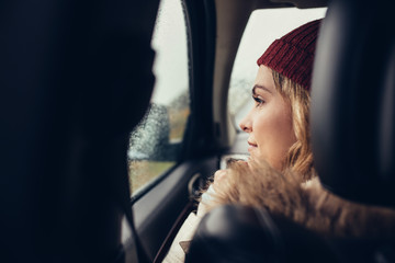 Fototapeta na wymiar Woman traveling by car and looking outside window