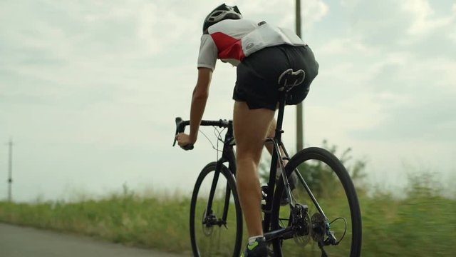 Handsome cyclist riding bike single track morning route rapid slow motion
