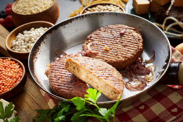 Veggie burger patties and ingredients in pan