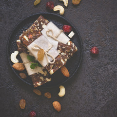 Healthy snack bars of dried fruits and nuts on black concrete background