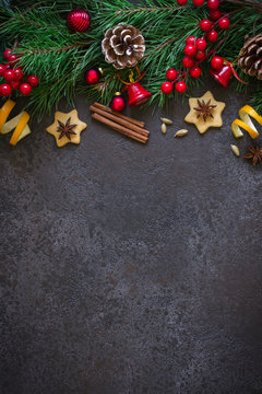 Christmas background border of fir branches and Christmas toys and spices. Top view with copy space