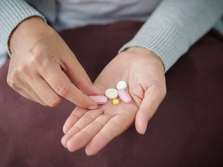 Closeup woman hand holding a pill. Healthcare, medical supplements concept