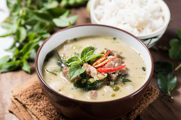 Thai food (Kaeng Khiao Wan),Green curry with pork and cooked rice on wooden background