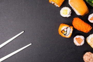 Top view of Sushi set and chopsticks on black background, Japanese food. Free space for text