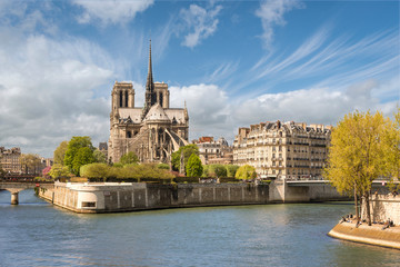 Paris, France - April 18, 2015: View from East across river Seine to Notre Dame de Paris cathedral.
