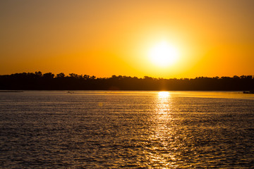 Naklejka premium golden sunset on a river in the nature