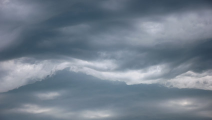 Stormy grey dramatic clouds in the daytime sky before thunderstorm