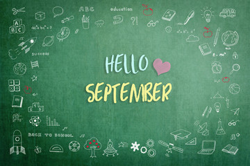 Hello September greeting on green school teacher's chalkboard with creative student's doodle of learning education graphic freehand illustration icon for back to school month concept