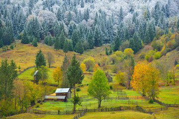 Two seasons, a rural landscape from a mountain region with autumn colors and some fresh snow