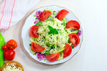 Homemade Zucchini Noodles Zoodles Pasta with Tomatos and cheese on white wooden background