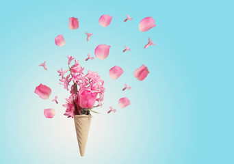 Flowers in a waffle cone on blue background
