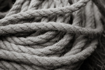 Fototapeta na wymiar Old fashioned household rope. Black and white photo
