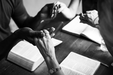 Group of people holding hands praying worship believe