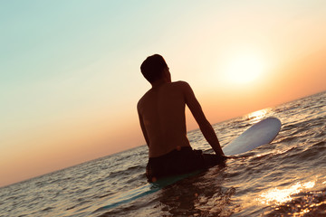 A surfer at sunset.