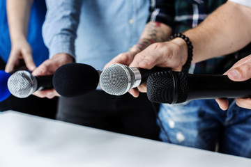 Hands holding microphone for an interview