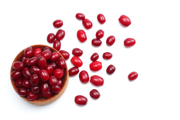 dogwood berries in wooden bowl isolated on white background. top view