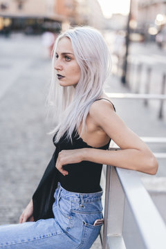 Young cool woman in the city at sunset