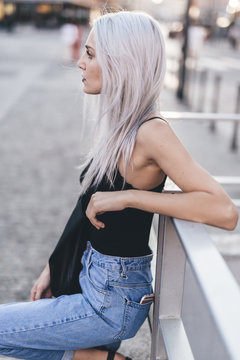 Young cool woman in the city at sunset