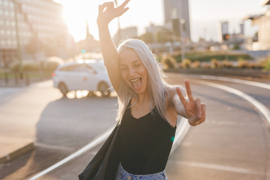 Young cool woman in the city at sunset