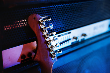 Guitar lean on an amplifier - obrazy, fototapety, plakaty