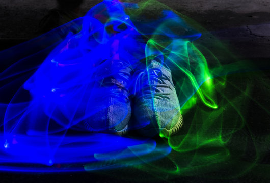 Long Exposure Blue And Green Light Lines Movement Over Sneakers