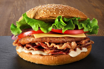 Home made hamburger with lettuce, cheese and bacon.