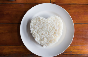 Cooked rice in a Plate on a table background.