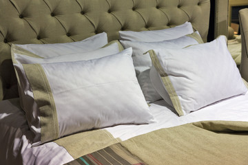 Fototapeta na wymiar stylish bedroom interior with pillows on bed