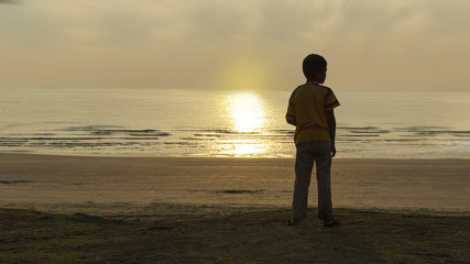 boys playing on the beach, sunrise
