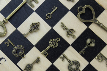 Vintage keys on a chessboard