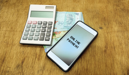 caculator, banknote, smartphone with the word "ONLINE PAYMENT"