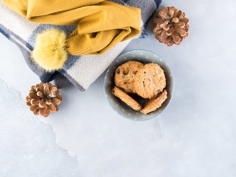 Home winter relax with woolen plaid and chocolate chip cookies. Time for cozy blanket sweater sweet snack