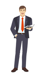 Businessman with hand in pocket holding book