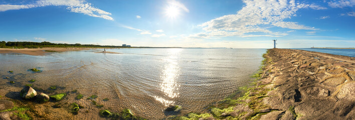 Panoramic image of a seaside with old lighthouse iin Swinoujscie