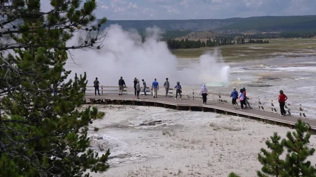 Tourists walking on footbridge by Yellowstone geysers