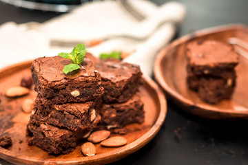 Brownie stack, closeup chocolate cake in plate on rustic wooden table
