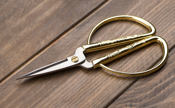 Sewing Scissors On Wooden Table.