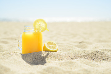 Fototapeta na wymiar Juice in a jar on the beach