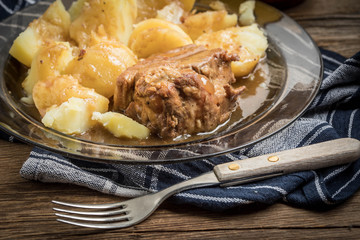 Stewed pork meat served with potatoes
